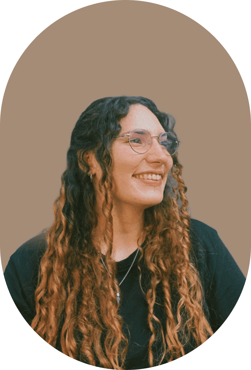 Juliana smiling, with long curly hair and glasses